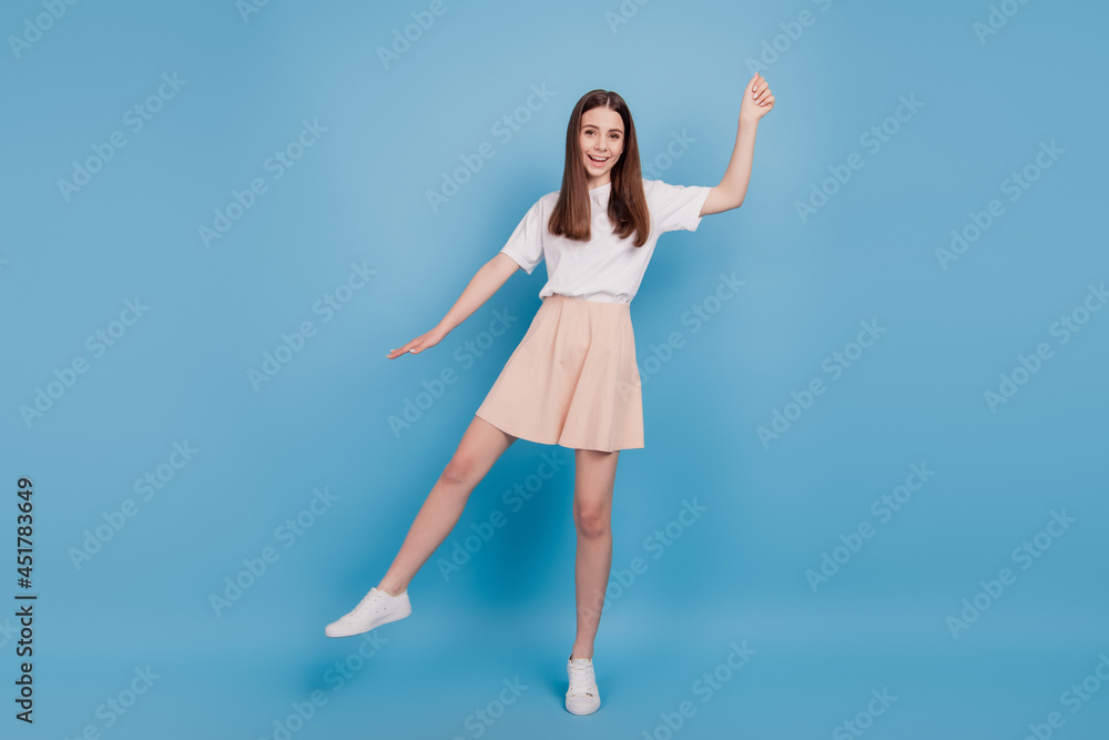 Portrait of dreamy cheerful positive cute playful teen lady hold invisible umbrella on blue background