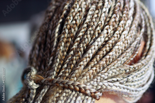 texture of krupnyeh braids on the head, rows, cornRow photo