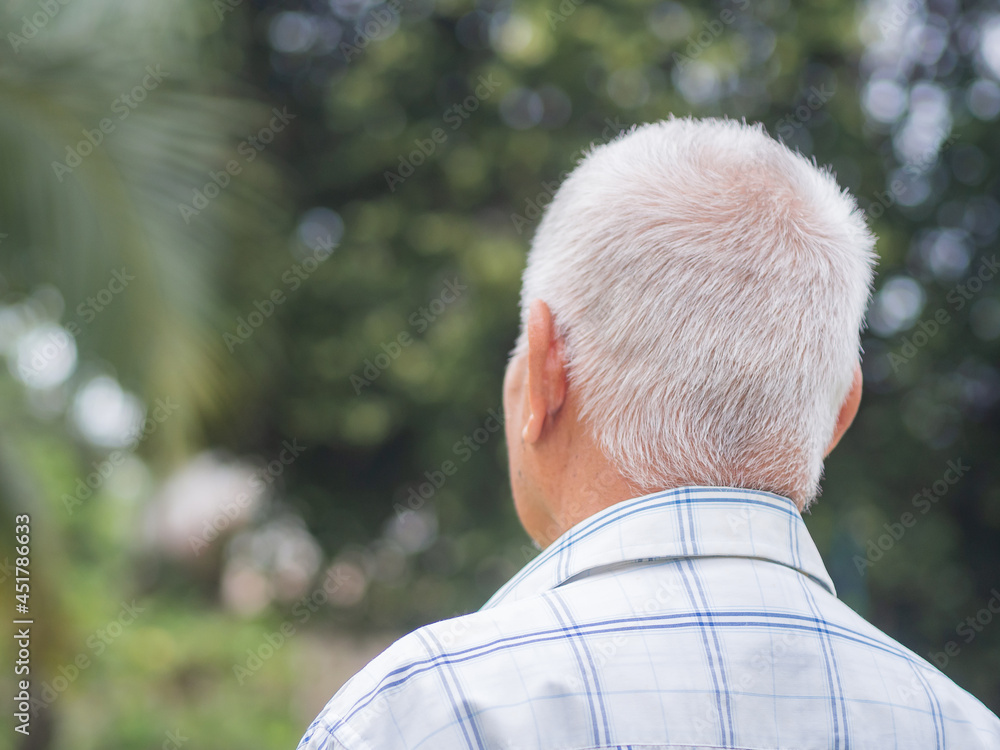 Back view of an elderly man with short gray hair while standing outdoors. Space for text. Aged people and relaxation concept Back view of an elderly man with short gray hair while standing outdoors. Space for text. Aged people and relaxation concept