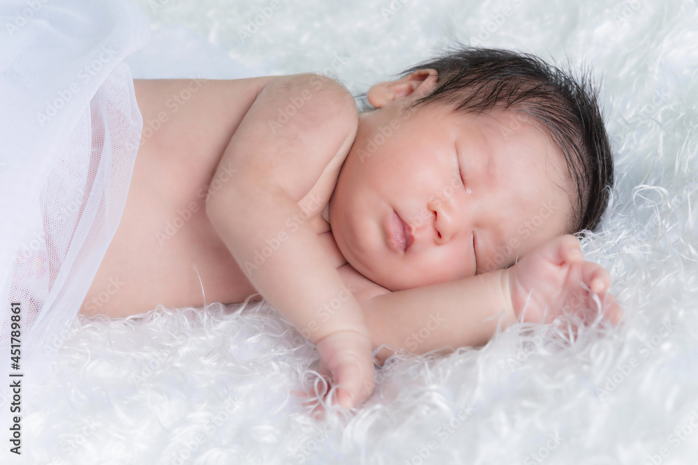 Newborn baby girl wearing angel wing. Newborn baby girl wearing angel wing.