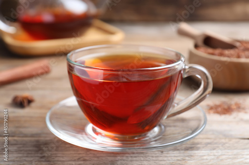Freshly brewed rooibos tea on wooden table  closeup