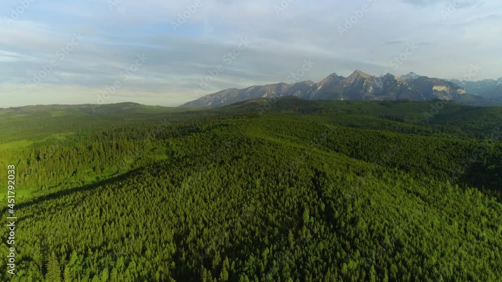Mountain aerial during summer, epic view. Aerial view of mountain landscape with green forest and meadow. Tatra high mountains in the sunny morning after sunrise. Drone footage of magical alpine scene Mountain aerial during summer, epic view. Aerial view of mountain landscape with green forest and meadow. Tatra high mountains in the sunny morning after sunrise. Drone footage of magical alpine scene