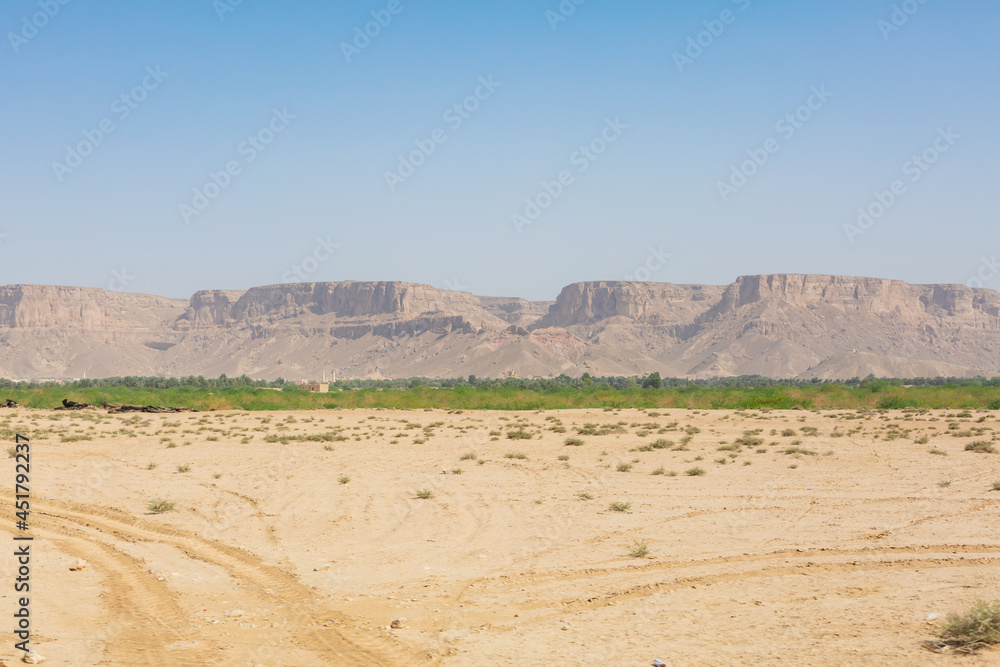 scenery of vast wilderness, rocky mountains, and blue sky in hadramaut, yemen