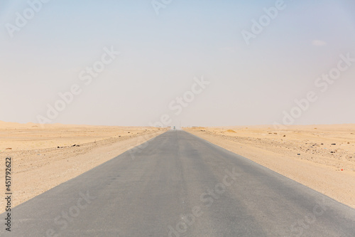 long straight empty road surrounded by desert in hadramaut  yemen