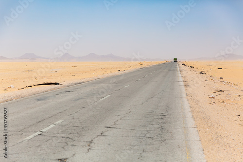 long straight empty road surrounded by desert in hadramaut  yemen