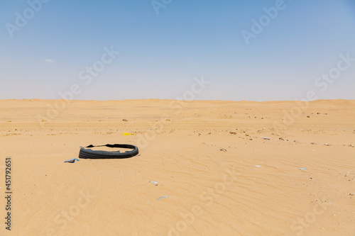 Fototapeta Naklejka Na Ścianę i Meble -  abandoned old tire in the vast desert in marib, yemen