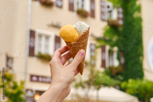 Delicious classic ice cream in woman hands. Natural homemade gelato close up. Summer sweet tasty dessert. Refreshes in hot weather. Healthy eating, organic food. Take away traditional product