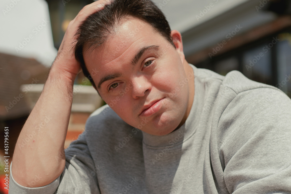 Portrait of young man with Down Syndrome in active wear smiling Portrait of young man with Down Syndrome in active wear smiling