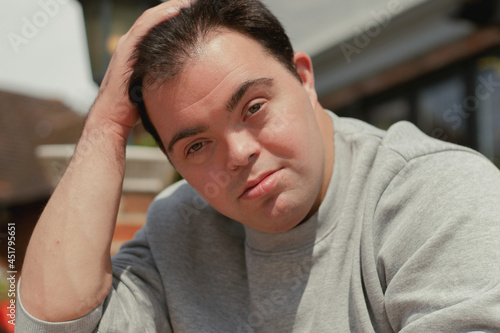 Portrait of young man with Down Syndrome in active wear smiling