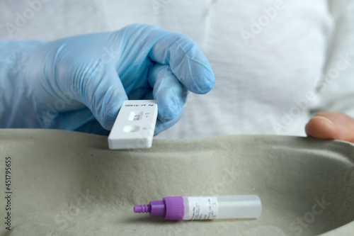 close-up of a male medic's hand holding a test cassette, medical disposable sterile test kit for rapid test covid-19, concept of early detection of viral disease, SARS-CoV-2 epidemic, coronavirus