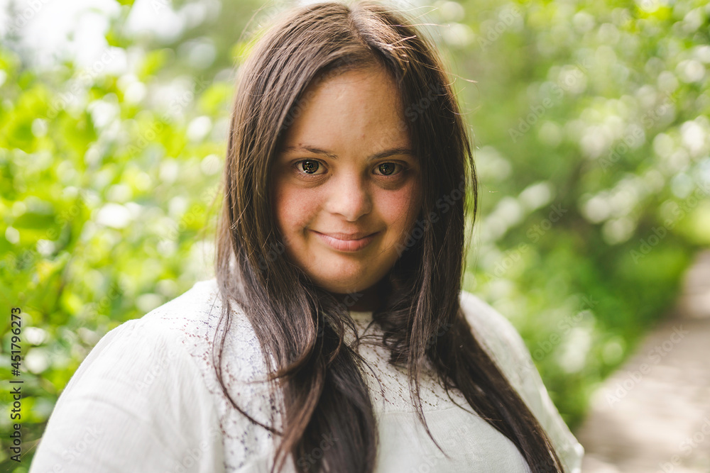 Portrait of trisomy adult outside having fun