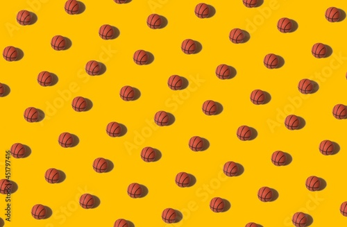 Background for design and banners. A basketball with a shadow on a yellow background. Pattern