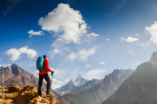 Hiker on the top in Himalayas mountains. Travel sport lifestyle concept © olyphotostories