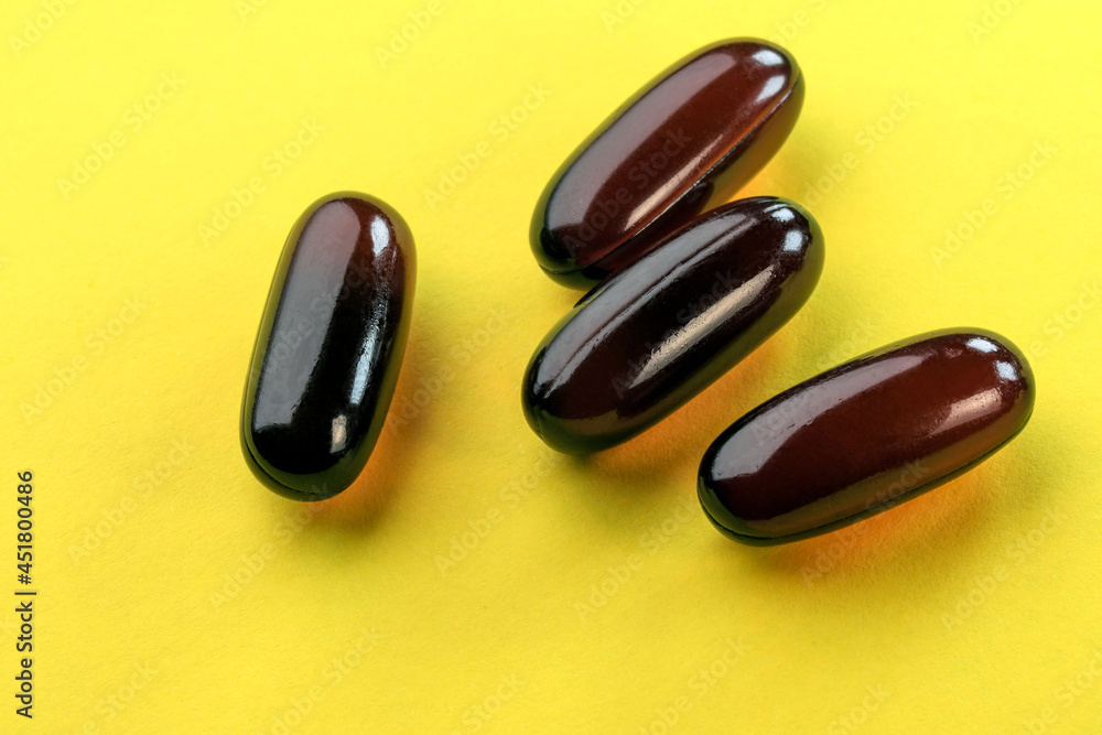 Vitamins in brown gelatin capsule Vitamins in brown gelatin capsule