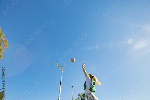 horizontal shot of a young woman celebrating after scoring in a net ball game