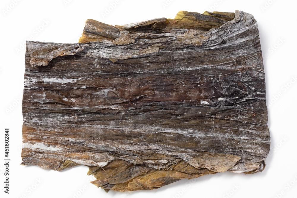 Dried nori seaweed laminaria sheets. Nori seaweed dried in flat sheets. Wrinkled brown background. For making sushi, rolls and other dishes. Background for asian food. Crispy dried seaweed. Dried nori seaweed laminaria sheets. Nori seaweed dried in flat sheets. Wrinkled brown background. For making sushi, rolls and other dishes. Background for asian food. Crispy dried seaweed.