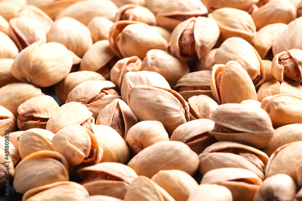 Scattered pistachio nuts. Background. Selective focus. Close-up. Scattered pistachio nuts. Background. Selective focus. Close-up.