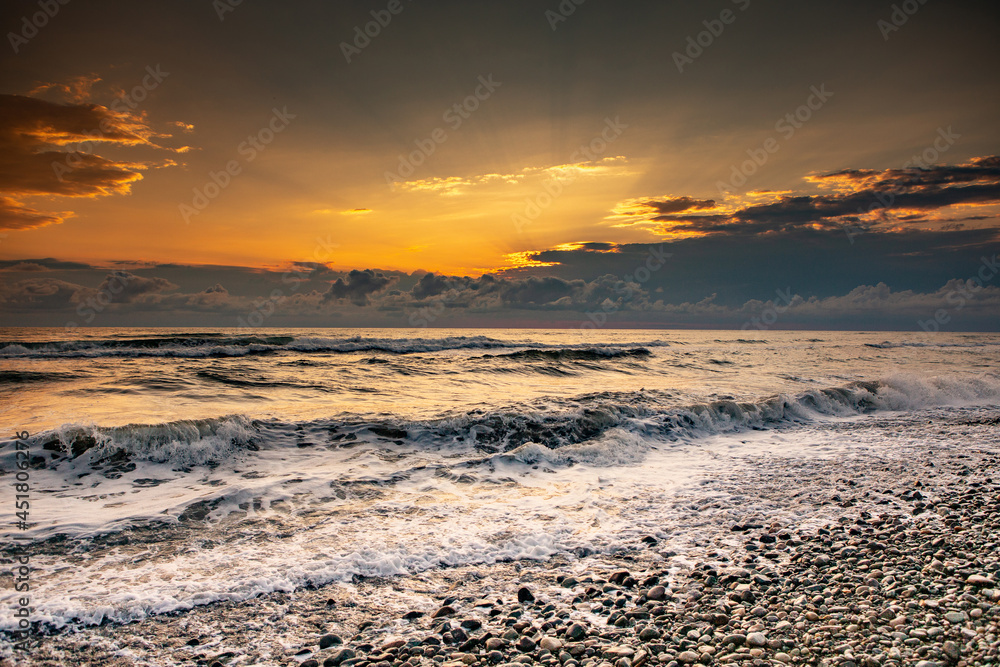 Charming sunset on the black sea beach in Georgia.