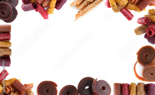 Frame made of delicious fruit leather rolls on white background