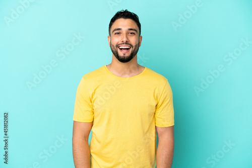 Young arab man isolated on blue background with surprise facial expression
