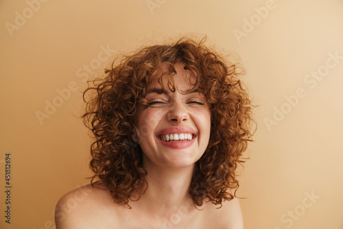Half-naked ginger woman laughing while posing at camera