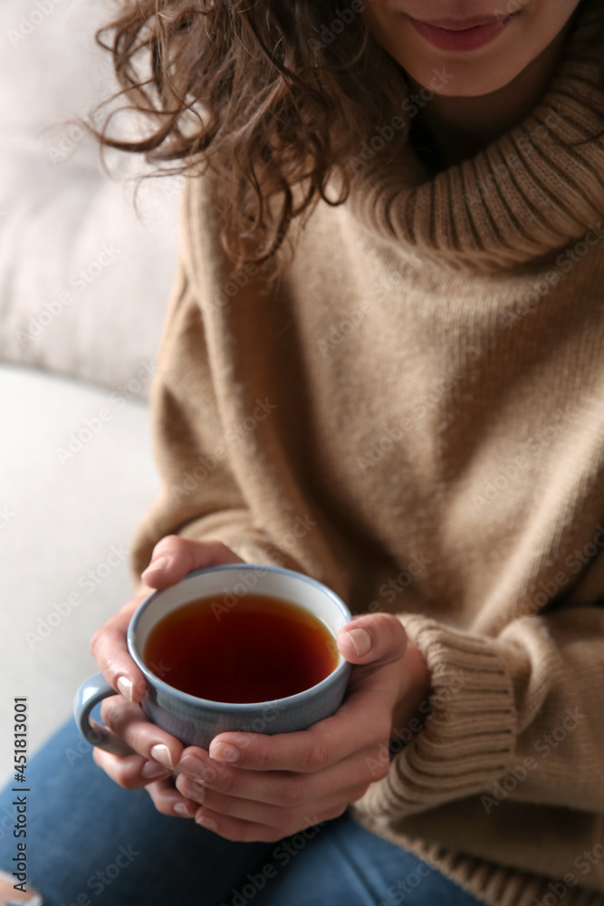 Woman with cup of hot tea indoors, closeup. Cozy home atmosphere Woman with cup of hot tea indoors, closeup. Cozy home atmosphere