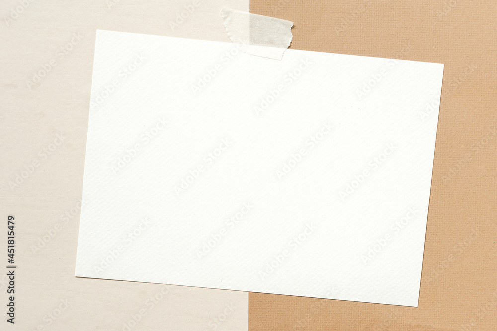 masking tape stick on blank white mock up brochure placed on beige and brown paper background. masking tape stick on blank white mock up brochure placed on beige and brown paper background.