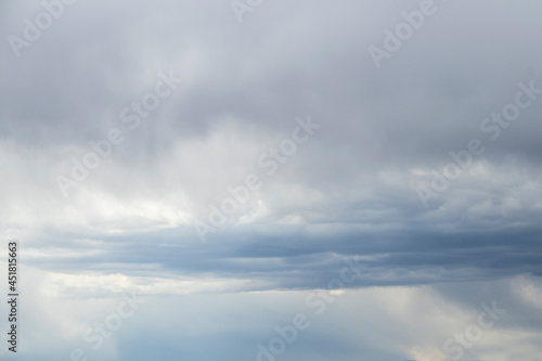 Fototapeta Naklejka Na Ścianę i Meble -  Stormy sky with flat bluish cloud - blue sky below and grey clouds above - before a rain shower.