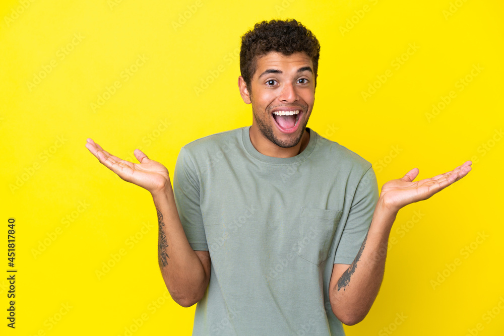 Young handsome Brazilian man isolated on yellow background with shocked facial expression Young handsome Brazilian man isolated on yellow background with shocked facial expression