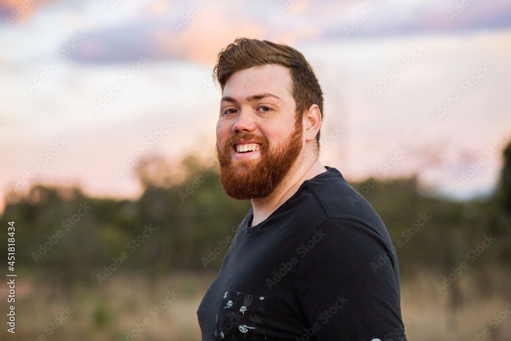 Portrait of happy bearded australian man outside at dusk Portrait of happy bearded australian man outside at dusk