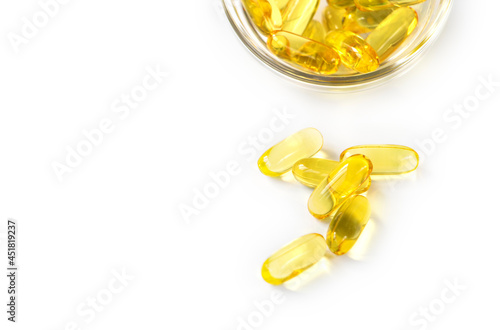 Omega 3 capsules lying on white background. Fish oil in pills. Health support and treatment. Biologically active additives. Selective focus. Healthy food concept. High quality photo