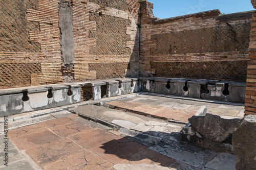 Fototapeta Naklejka Na Ścianę i Meble -  Latrina presso le terme del foro. Ancient public toilets (latrines) located at Ostia Atica (the ancient port of Rome)