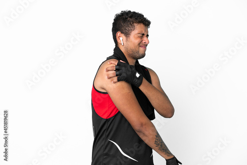 Sport brazilian man with towel isolated on white background suffering from pain in shoulder for having made an effort © luismolinero