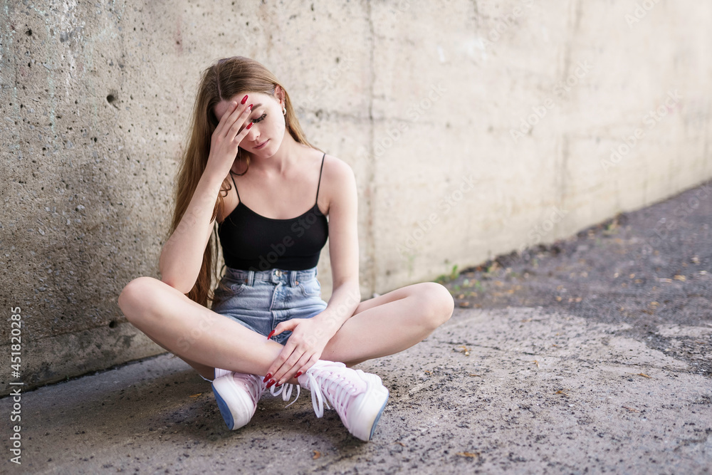 Outdoor portrait of a sad teenage girl looking thoughtful about troubles Outdoor portrait of a sad teenage girl looking thoughtful about troubles