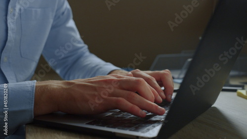 Businessman hands typing email message on laptop. Guy browsing internet online