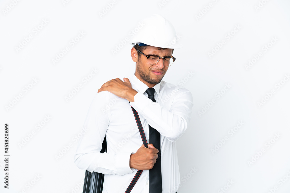 Architect brazilian man with helmet and holding blueprints suffering from pain in shoulder for having made an effort Architect brazilian man with helmet and holding blueprints suffering from pain in shoulder for having made an effort