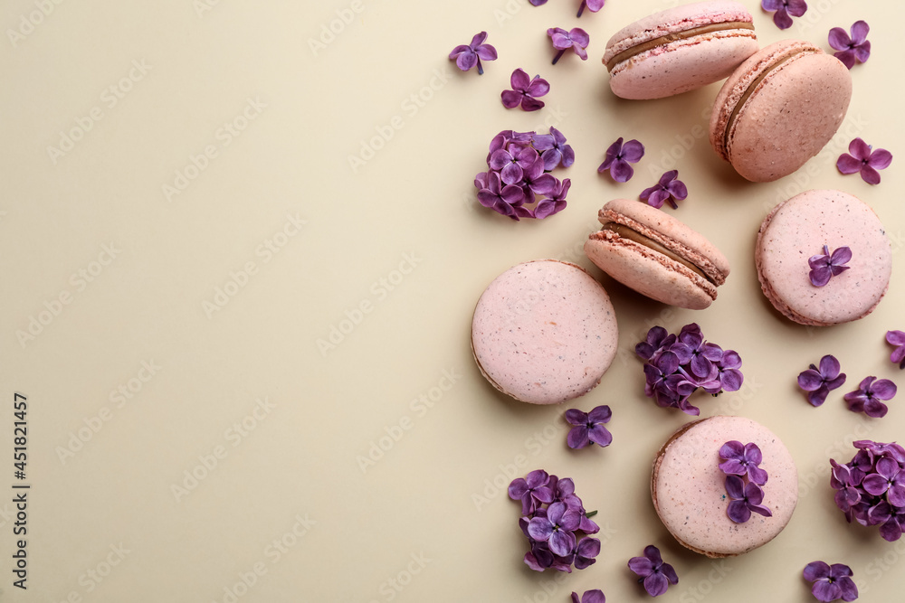 Flat lay composition with macarons and lilac flowers on beige background. Space for text Flat lay composition with macarons and lilac flowers on beige background. Space for text