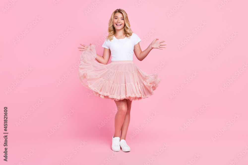 Full body photo of young attractive excited girl happy positive smile wear skirt isolated over pink color background Full body photo of young attractive excited girl happy positive smile wear skirt isolated over pink color background