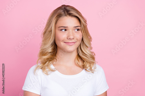 Photo of young attractive girl happy positive smile curious look empty space isolated over pink color background