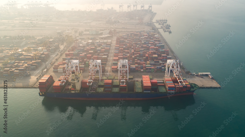 Obraz premium Container ship in export and import business and logistics. Shipping cargo to harbor by crane. Water transport International. Aerial view and top view. 