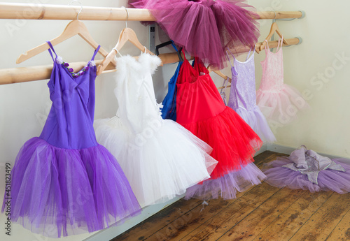 ballet school outfits hanging on a rail