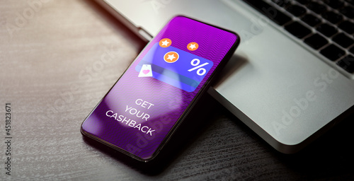 Cashback customer loyalty program concept. Smartphone with discount card with rewarding marketing points on the screen and text - get your cashback. Rewards and money refund service.