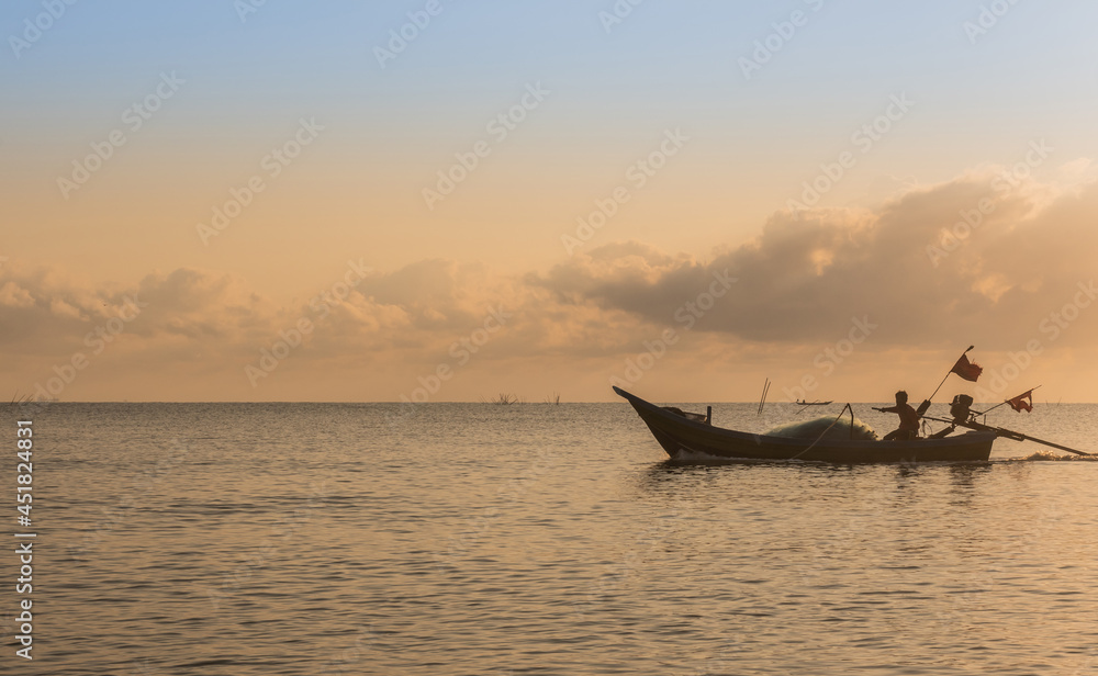 Silhouette of fishing boat and man in morning in Thailand, Nature and culture concept.