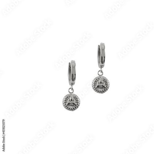 Silver earrings with protection symbol isolated on a white background.