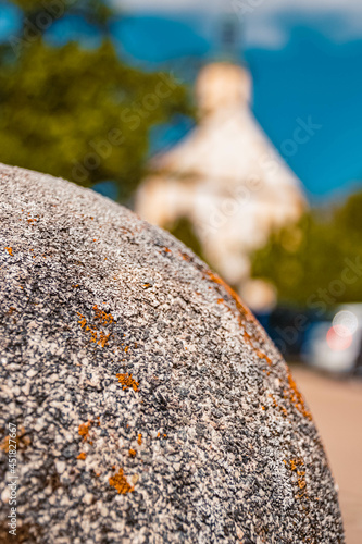 Details of a stone post with the pilgrimage church Maria Bruennlein in the background at the famous Noerdlinger Ries crater, Wemding, Bavaria, Germany photo
