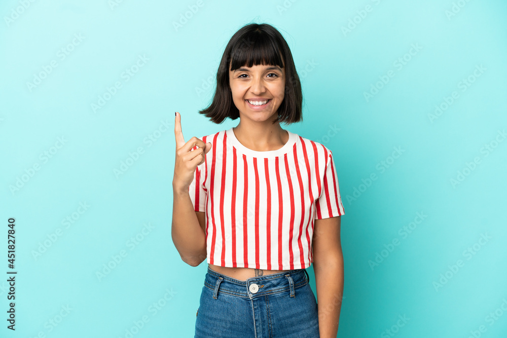 Young mixed race woman isolated on blue background pointing up a great idea Young mixed race woman isolated on blue background pointing up a great idea