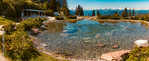 High resolution stitched panorama of a beautiful alpine summer view with reflections in a pond at the famous Steinplatte summit, Waidring, Tyrol, Austria photo