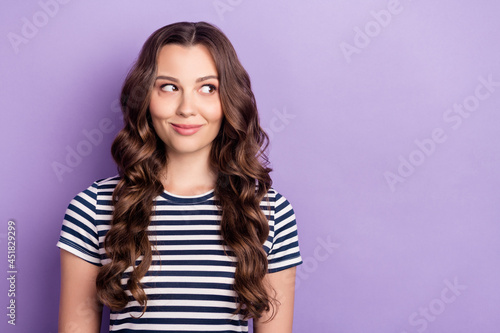 Photo of dreamy sweet young woman dressed striped t-shirt looking empty space smiling isolated violet color background