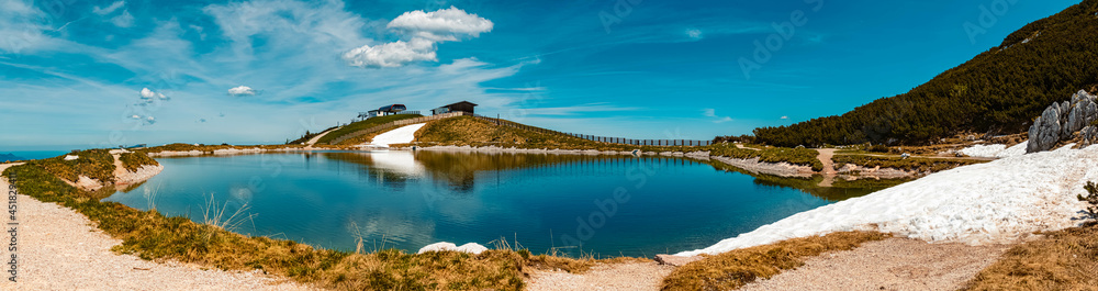 High resolution stitched panorama of a beautiful alpine summer view with reflections in a pond at the famous Steinplatte summit, Waidring, Tyrol, Austria
