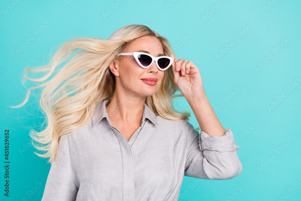 Profile photo of calm serene charming lady look empty space wear sunglass grey shirt isolated turquoise color background Profile photo of calm serene charming lady look empty space wear sunglass grey shirt isolated turquoise color background